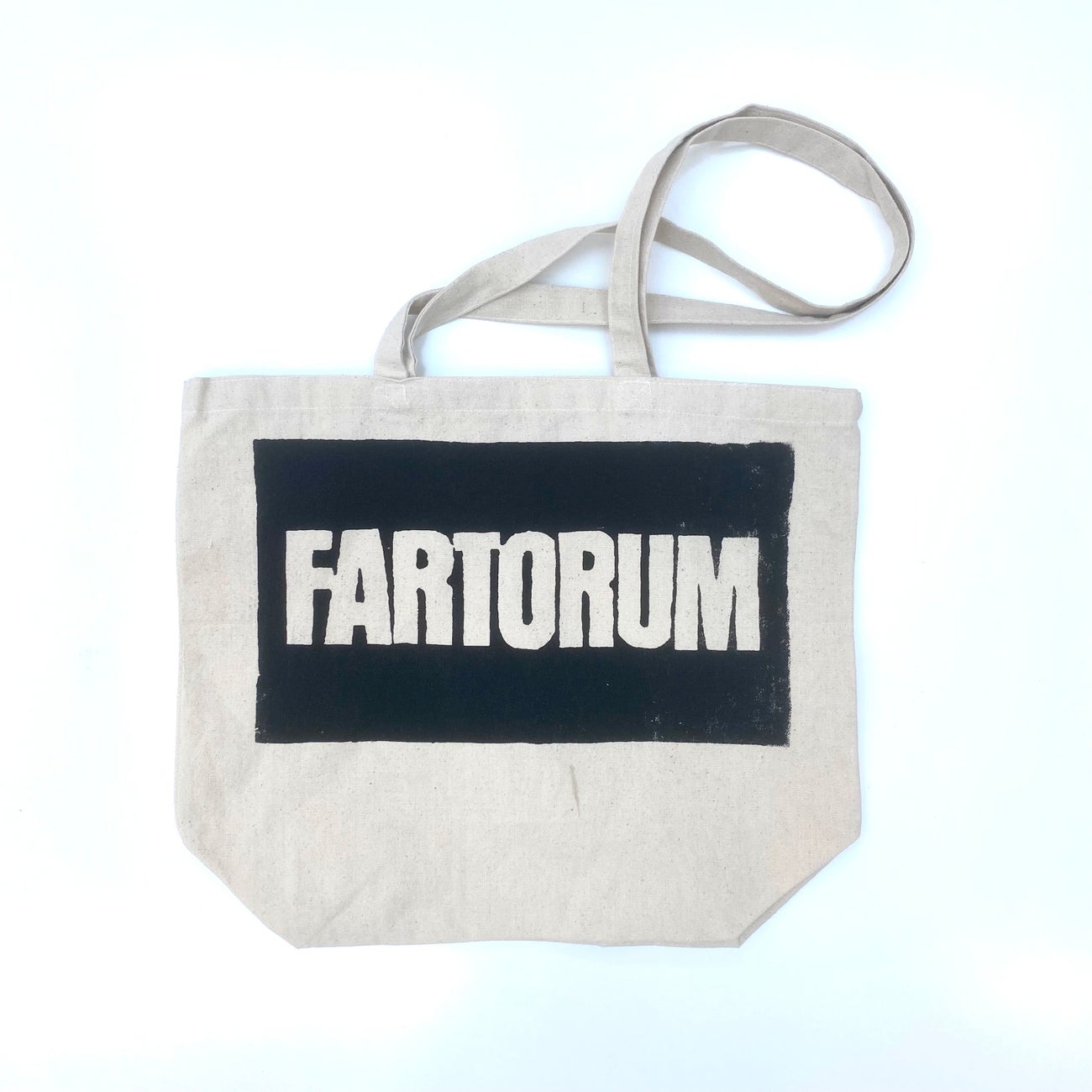 a tote bag with Fartorum screen printed on the side